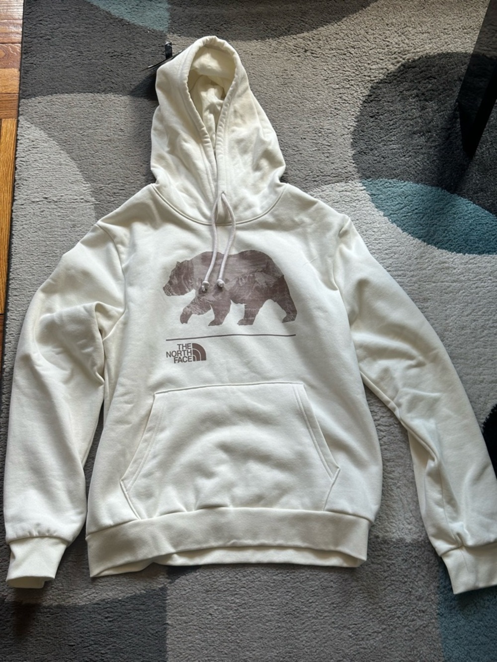 The North Face Cream Hoodie with Bear Graphic